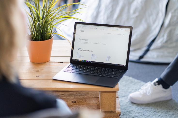 Laptop on a desk with Microsoft content